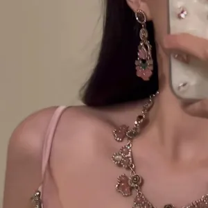 Detailed macro view of elegant pink resin flower necklace with rhinestone accents