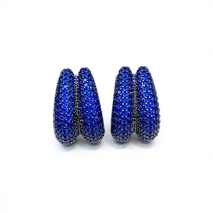Pair of fashion earrings with double-row blue zircon stones on white background