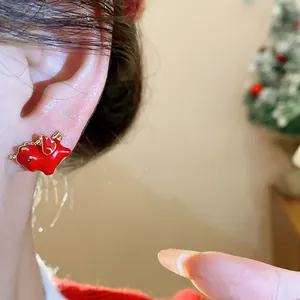 Close-up of red enamel pony earring with silver needle for New Year decoration