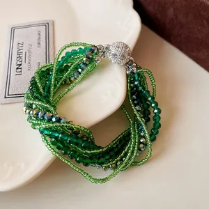 Detail of green multi-layer crystal bead bracelet with sparkling rhinestone magnetic clasp