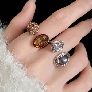 Elegant vintage oval rhinestone open ring featuring pearl and crystal accents worn on hand