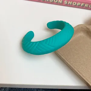 Turquoise resin cuff bracelet with textured wave pattern in matte finish