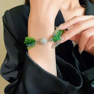 Close-up of green multi-layer crystal bead bracelet with rhinestone magnetic clasp