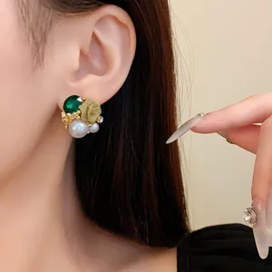 Vue détaillée de boucles d'oreilles de style vintage français avec perles et gemmes.