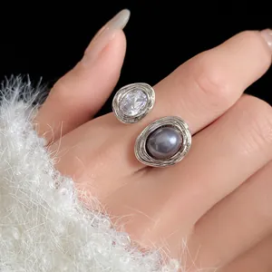 Close-up of elegant open ring with sparkling crystal and grey pearl detail