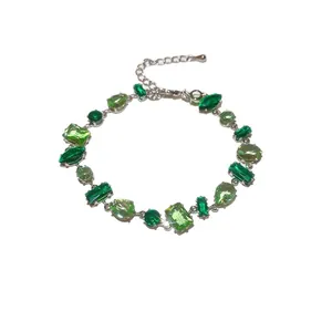 Sparkling silver bracelet featuring multi-shaped green zircon gems in an elegant design