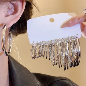 Silver geometric hoop earring set in various sizes and textures shown on display card