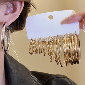 Detailed view of assorted gold hoop earrings set with varied textures and sizes