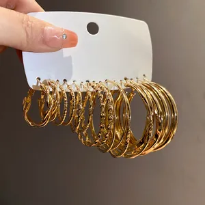 Detailed view of assorted gold-tone hoop earring set with twisted and smooth textures