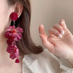 Detailed view of cascading red rose and purple fabric flower drop earrings.