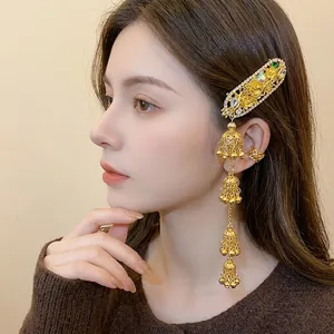 Elegant ethnic style gold hair clip with rhinestone floral oval and bell tassels