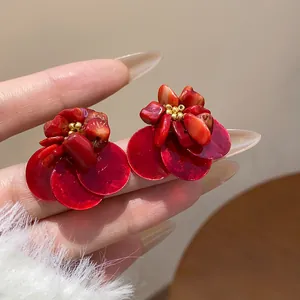 Detailed view of vintage red shell earrings with stone and gold bead accents