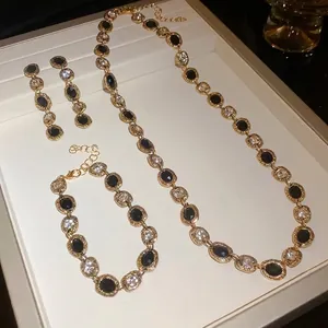 Elegant three-piece gold-tone jewelry set including necklace bracelet and earrings with stones