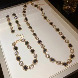 Elegant jewelry set featuring black and clear crystal oval links with gold plating