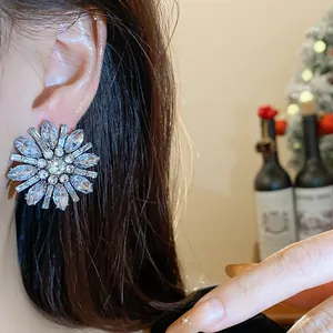 Primo piano di un orecchino a perno a forma di fiore con strass indossato