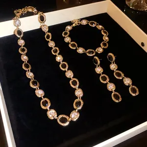 Elegant jewelry set featuring irregular oval links with black stones and clear crystals.