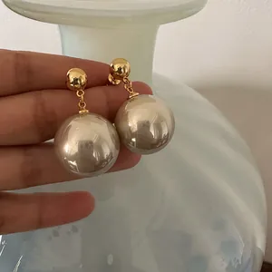 Close-up detail of French vintage gold plated drop earrings with oversized pearls