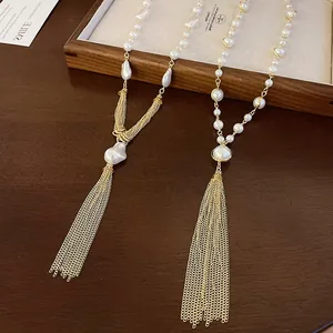 Macro detail view of elegant artificial pearl tassel necklaces on vintage wooden surface