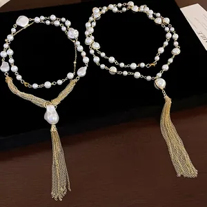 Detailed close-up of elegant vintage faux pearl tassel necklace with delicate gold chains