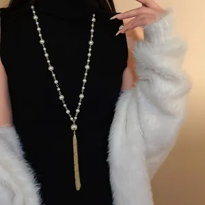 Elegant vintage-style long faux pearl tassel sweater chain necklace on a model
