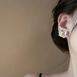 Elegant silver needle resin flower stud earrings for women shown on model ear in soft lighting