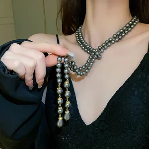 Detailed view of grey multi-layer pearl necklace with elegant teardrop pendant
