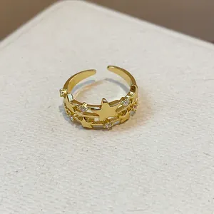Detailed view of a multi-layer gold open ring with sparkling zircon star charms