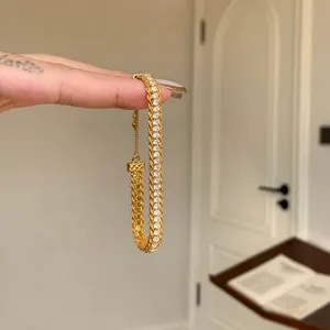 Detailed view of an elegant gold zircon snake bracelet featuring an intricate braided design