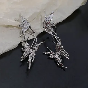 Detail of silver butterfly ear cuff and stud combo with unique wrinkled texture