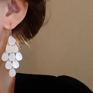Elegant Korean style white water-drop tassel earrings with shimmering shell-like finish.
