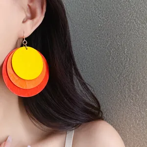 Oversized multi-layered circular wooden earrings in yellow orange and red vacation style