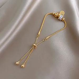Élégant bracelet réglable doré avec breloque cylindre en cristal et pendentif cœur