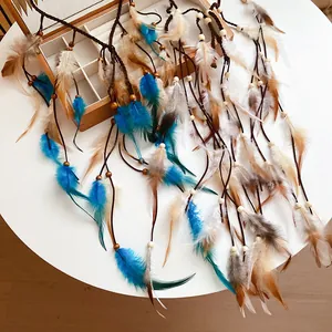 Detail of intricate Bohemian feather tassels and wooden beads on an ethnic hairband