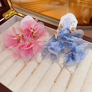 Detailed view of elegant mesh flower drop earrings in vibrant pink and blue colors