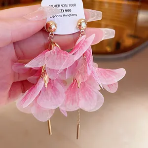 Detailed close-up of elegant pink mesh petal earrings with gold-toned studs and dangles