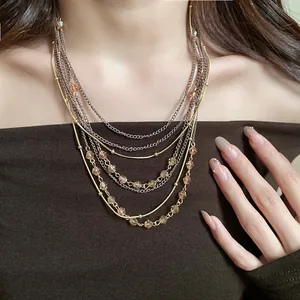 Detail view of multi-layered vintage necklace with champagne glass beads on model