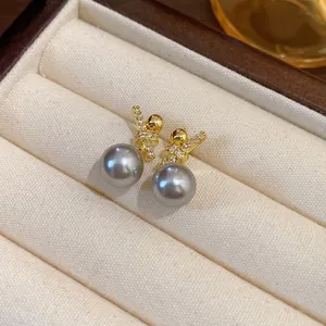 Elegant gold-plated grey pearl stud earrings with sparkling zircon accents in jewelry box