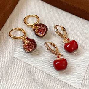 Gold plated earrings set featuring pomegranate with zircons and red enamel apple designs