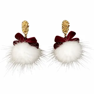 White faux fur pom pom earrings with maroon velvet bow and gold textured metal top