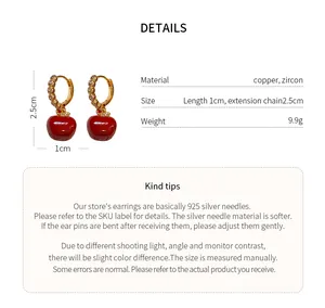 Detailed view of gold-plated apple earrings with material and size specifications
