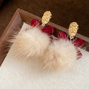 Furry pom pom earrings with red velvet bow and gold textured studs for winter