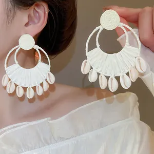 Handmade white straw braided hoop earrings with natural shell pendants for beach