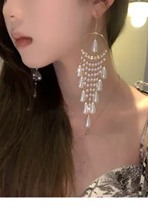 Elegant French palace style zircon and pearl long tassel earrings worn by an Asian model