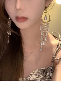 Elegant long pearl tassel earrings in vintage French style worn by an Asian model