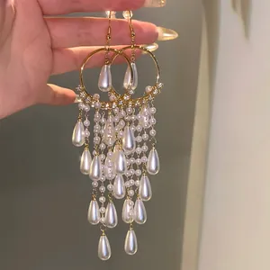 Elegant long tassel earrings with teardrop pearls and sparkling zircons in vintage style