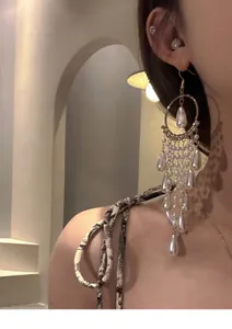 Close-up view of elegant French palace style long tassel earrings with white pearls