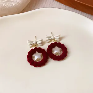 Elegant red flocked bow earrings featuring a central pearl star detail for autumn