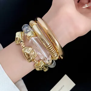 Minimalist chunky metal and clear acrylic geometric bracelet four-piece set on a wrist