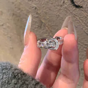 Gros plan détaillé d'une bague ouverte à boucle fer à cheval sertie de zircons