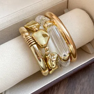 Macro view of geometric gold and acrylic bracelet set on professional jewelry display